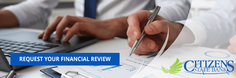 Businessman with Banker Reviewing Financial Statements